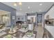 Open-concept kitchen with stainless steel appliances and a large island flows into a dining area, perfect for gatherings at 2322 E Mews Rd, Gilbert, AZ 85298