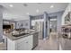 Modern kitchen features stainless steel appliances, granite countertops, and an open layout with sightlines to the living room at 2322 E Mews Rd, Gilbert, AZ 85298