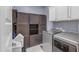 Laundry room with gray appliances, cabinets, and tile flooring at 2322 E Mews Rd, Gilbert, AZ 85298