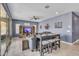 Spacious living room features a ceiling fan, entertainment center, and plenty of seating for guests at 2322 E Mews Rd, Gilbert, AZ 85298