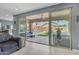 Cozy living area features an expansive sliding glass door that leads to an outdoor patio with a pool and seating at 2322 E Mews Rd, Gilbert, AZ 85298