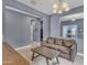 Cozy living room with gray walls and tile floors, featuring a comfortable sofa and a stylish coffee table at 2322 E Mews Rd, Gilbert, AZ 85298