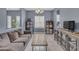 Inviting living room featuring modern decor, shelving units, stylish console, neutral color palette, and an abundance of natural light at 2322 E Mews Rd, Gilbert, AZ 85298