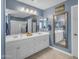 Bright main bathroom showcasing double sinks, a large mirror, and a glass shower at 2322 E Mews Rd, Gilbert, AZ 85298