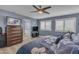 Relaxing main bedroom showcasing plantation shutters, ceiling fan, and ensuite bathroom with soaking tub at 2322 E Mews Rd, Gilbert, AZ 85298