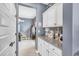 Organized butler's pantry offers ample storage with granite counters and white cabinets for kitchen essentials at 2322 E Mews Rd, Gilbert, AZ 85298