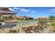 Resort-style pool area with comfortable lounge chairs and shade structures on a sunny day at 2322 E Mews Rd, Gilbert, AZ 85298