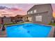 Stunning pool with steps, surrounded by artificial turf and lounge areas creates an inviting backyard retreat at 2322 E Mews Rd, Gilbert, AZ 85298