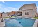 Inviting backyard pool with lounge area, well-manicured landscaping, and a relaxing ambiance at 2322 E Mews Rd, Gilbert, AZ 85298