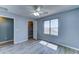 Bedroom featuring laminate floors, neutral paint, ceiling fan, and walk-in closet at 23773 W Hammond Ln, Buckeye, AZ 85326
