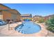 Backyard pool featuring stone surround, steps, and lovely desert landscaping at 23773 W Hammond Ln, Buckeye, AZ 85326