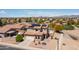 Aerial view of a home with a pool, solar panels, a desert landscaped yard and mountain views at 25606 W Satellite Ln, Buckeye, AZ 85326