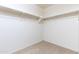 Empty closet, ready to customize for storage with a neutral carpet and freshly painted walls at 25606 W Satellite Ln, Buckeye, AZ 85326