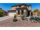 Beautiful two-story home featuring a desert landscape with rock accents and a two car garage at 25606 W Satellite Ln, Buckeye, AZ 85326