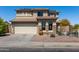 Inviting two-story home featuring a tile roof, desert landscaping, and a two-car garage at 25606 W Satellite Ln, Buckeye, AZ 85326