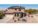 Inviting two-story home featuring a tile roof, desert landscaping, and a two-car garage at 25606 W Satellite Ln, Buckeye, AZ 85326