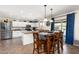 Open floor plan featuring the kitchen, dining area, and access to the backyard, with a view of the pool at 25606 W Satellite Ln, Buckeye, AZ 85326