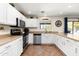 Kitchen with stainless steel appliances, white cabinets, tile floor, and stylish countertops for food preparation at 25606 W Satellite Ln, Buckeye, AZ 85326