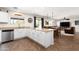 Eat-in kitchen featuring white cabinets, tile floor, stainless dishwasher, and a breakfast bar with room for seating at 25606 W Satellite Ln, Buckeye, AZ 85326