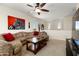 Living room showcases a large sectional sofa, coffee table, and a zebra artwork at 25606 W Satellite Ln, Buckeye, AZ 85326