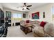 Living room features a large sectional sofa, coffee table, and a view from a picture window at 25606 W Satellite Ln, Buckeye, AZ 85326