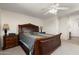 Main bedroom featuring a large bed, ceiling fan, and access to the en-suite bathroom and closet at 25606 W Satellite Ln, Buckeye, AZ 85326
