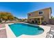 A backyard swimming pool with diving board and covered patio area is ready for entertaining at 25606 W Satellite Ln, Buckeye, AZ 85326
