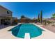 A backyard swimming pool with diving board and desert landscaping offers outdoor living at its finest at 25606 W Satellite Ln, Buckeye, AZ 85326