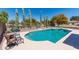 Sparkling pool with desert landscaping, diving board, and privacy fence at 25606 W Satellite Ln, Buckeye, AZ 85326