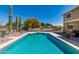 Sparkling pool with desert landscaping, diving board, and privacy fence at 25606 W Satellite Ln, Buckeye, AZ 85326