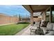 View of a cozy backyard with an artificial turf lawn, a patio, and a trampoline at 2822 E Hidalgo Ave, Phoenix, AZ 85040