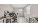 A modern bedroom with wood-look floors, a comfortable office chair, and two sunny windows at 2822 E Hidalgo Ave, Phoenix, AZ 85040