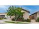 View of single-story home with well-maintained landscaping, a lush tree, and inviting curb appeal at 2822 E Hidalgo Ave, Phoenix, AZ 85040