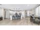 Well-lit kitchen featuring stainless steel appliances, a spacious island with seating, and a separate dining area at 2822 E Hidalgo Ave, Phoenix, AZ 85040