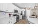 Modern kitchen featuring a white backsplash, stainless steel appliances, and sleek countertops at 2822 E Hidalgo Ave, Phoenix, AZ 85040