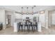 Spacious kitchen featuring an island with seating, modern lighting, white cabinets, and stainless steel appliances at 2822 E Hidalgo Ave, Phoenix, AZ 85040