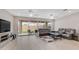 Open living area with large sliding doors, ceiling fans, and comfortable leather furniture at 2822 E Hidalgo Ave, Phoenix, AZ 85040