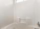 Bright white tiled bathtub with a shower niche and window providing natural light at 2906 W Irma Ln, Phoenix, AZ 85027
