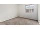 Cozy bedroom features neutral carpet, a large window, and ample natural light at 2906 W Irma Ln, Phoenix, AZ 85027