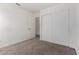 Neutral bedroom featuring sliding closet doors and tan carpet, ideal for relaxation at 2906 W Irma Ln, Phoenix, AZ 85027