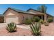 Beige single-story home featuring a two-car garage, desert landscaping, and a new roof at 2906 W Irma Ln, Phoenix, AZ 85027