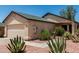 Beige single-story home featuring a two-car garage, desert landscaping, and a new roof at 2906 W Irma Ln, Phoenix, AZ 85027