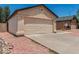 Beige single-story home featuring a two-car garage, desert landscaping, and a new roof at 2906 W Irma Ln, Phoenix, AZ 85027