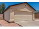 Beige single-story home featuring a two-car garage, desert landscaping, and a new roof at 2906 W Irma Ln, Phoenix, AZ 85027