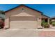 Beige single-story home featuring a two-car garage, desert landscaping, and a new roof at 2906 W Irma Ln, Phoenix, AZ 85027