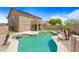 Beautiful pool and backyard showcasing landscaping, including palm trees at 2909 W Bowker St, Phoenix, AZ 85041