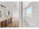 Bathroom boasts a brown vanity, sink, and a bright walk-in shower at 2909 W Bowker St, Phoenix, AZ 85041