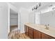 Bathroom features brown vanity and sink, large mirror, and a bright walk-in shower at 2909 W Bowker St, Phoenix, AZ 85041