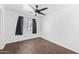 Bedroom with hard wood floors, ceiling fan, and window with neutral blinds at 2909 W Bowker St, Phoenix, AZ 85041