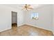 This bedroom features a ceiling fan and tile floors at 2909 W Bowker St, Phoenix, AZ 85041